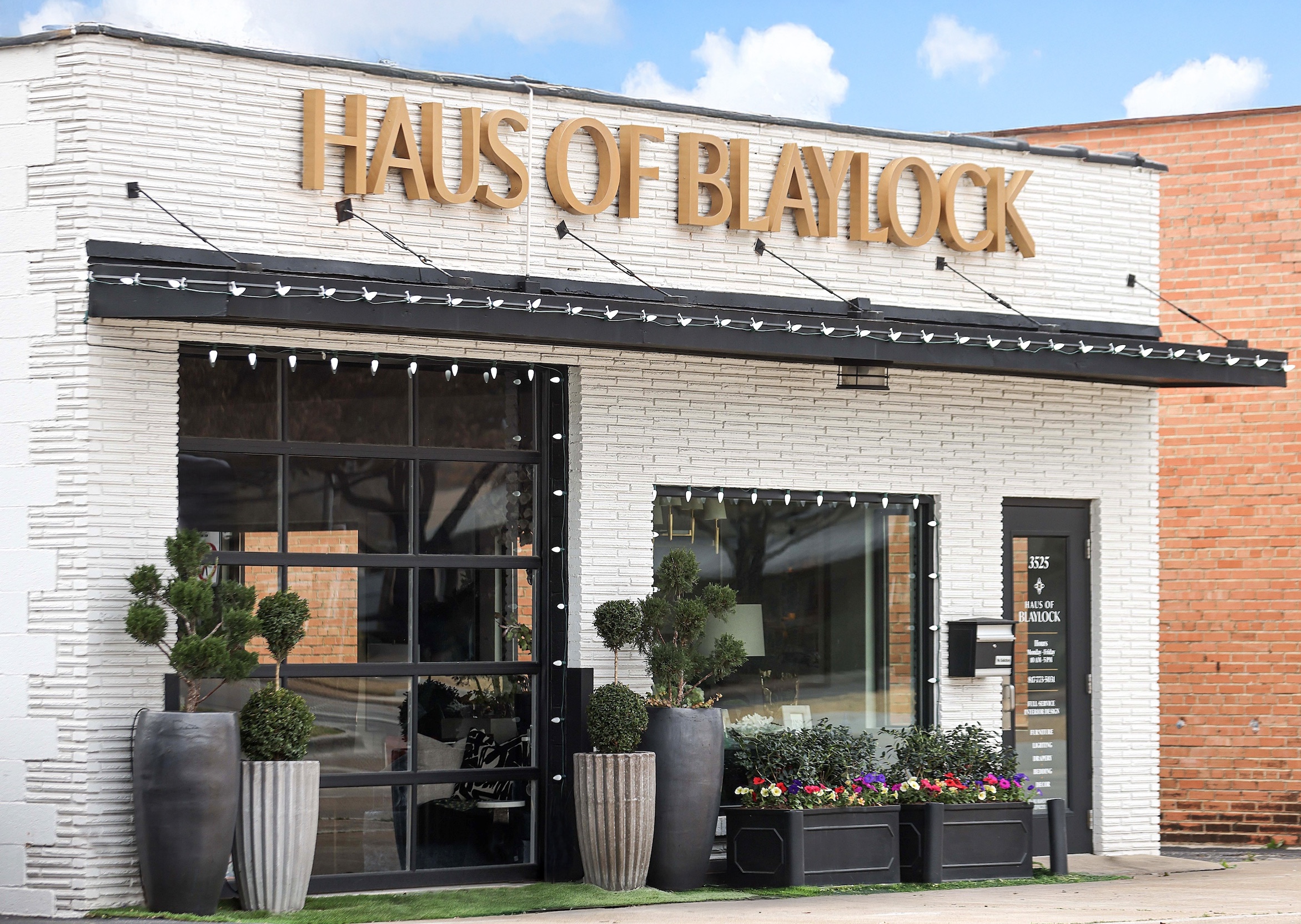 storefront of Haus of Blaylock interior design studio featuring gold signage and modern exterior styling